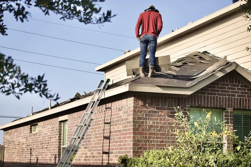 Professional roofer working on a residential roof in Fitchburg